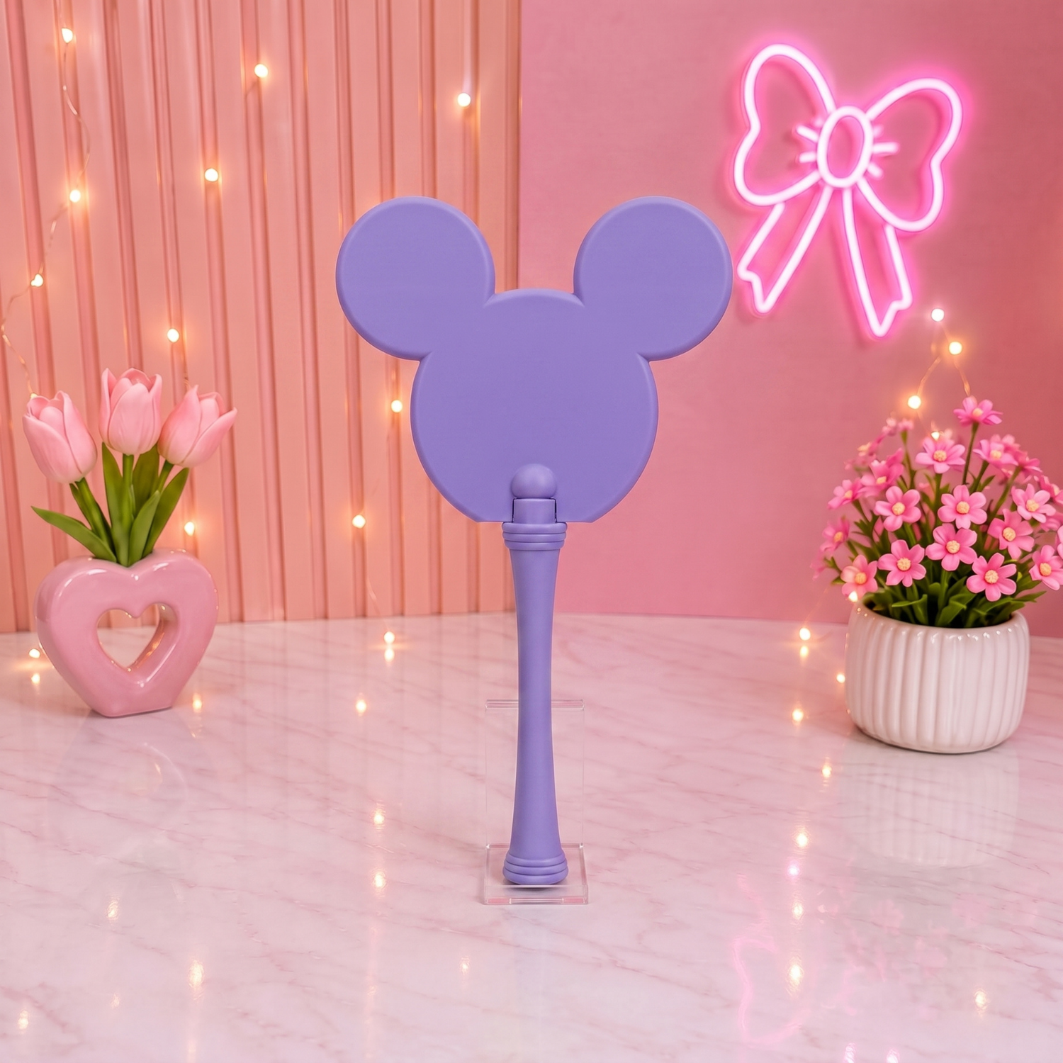 Purple fan with Mickey Mouse ears on a pink background with flowers and a neon bow.