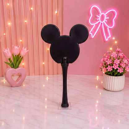 Black mirror with Mickey Mouse ears on a pink background with flowers and a neon bow.