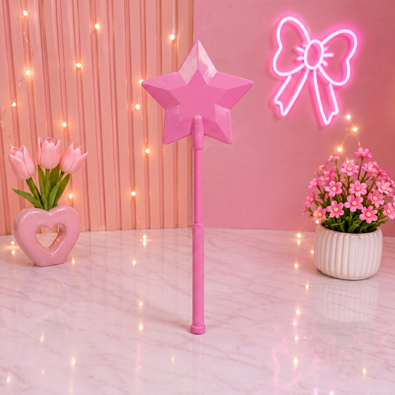 Pink star-shaped wand with neon bow and flowers on a pink background